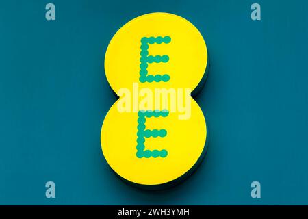 Cardiff, Wales, UK - December 6 2023: An illuminated EE Mobile Sign on the EE Store in Queen Street, Cardiff, Wales, UK Stock Photo