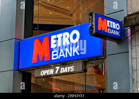 Cardiff, Wales, UK - December 6 2023: Illuminated Metro Bank Signs in Queen Street, Cardiff, Wales, United Kingdom Stock Photo