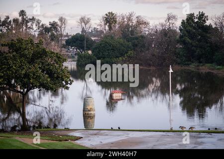 Lower playground and large pond at Polliwog Park flooded by the rain in Manhattan Beach, CA Stock Photo