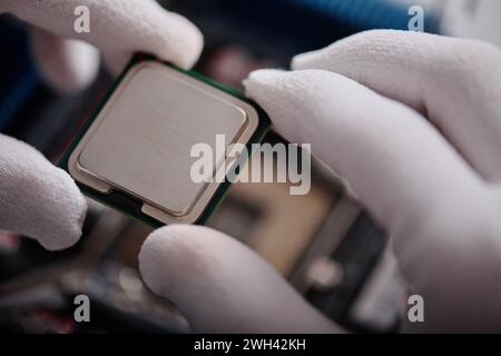 Extreme closeup of central processing unit in gloved hands of unrecognizable technician, copy space Stock Photo