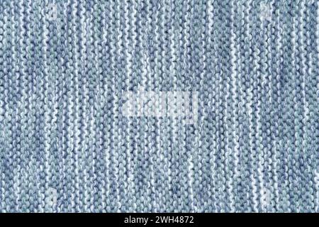 Knitted melange background from woollen yarns in blue and white colors. Abstract grunge overlay texture of a knitted fabric. Stock Photo