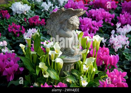 A sculpture with flowers surrounding in springtime Stock Photo