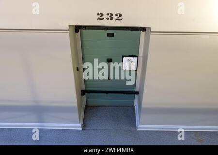 A cell door in a prison corridor Stock Photo