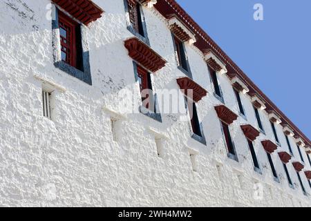 Weathered windows line Potala Palace, once home to the Dalai Lama. The palace is located in Lhasa, the capital of the Tibet Autonomous Region of China Stock Photo