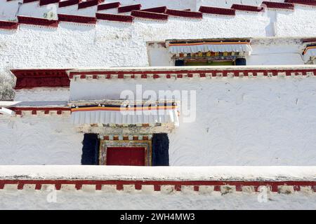 Weathered windows line Potala Palace, once home to the Dalai Lama. The palace is located in Lhasa, the capital of the Tibet Autonomous Region of China Stock Photo