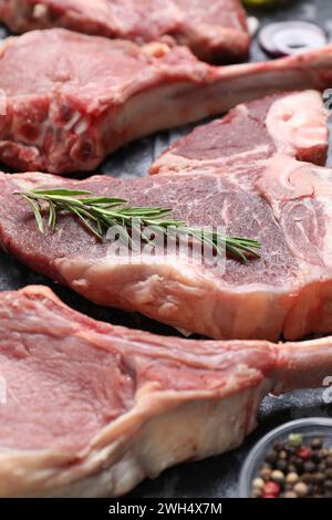 Fresh raw beef cuts and different spices on table, closeup Stock Photo
