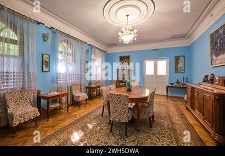 View of the large, blue dining room with wood furniture. At the writer and social activist Mukhtar Auezov Literature Memorial House in Almaty, Kazakhs Stock Photo
