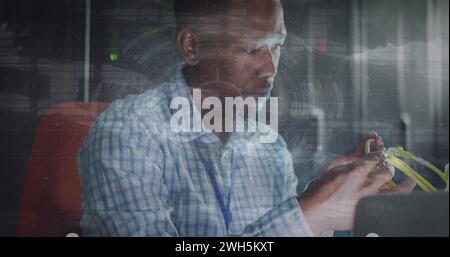 Image of data processing over african american male worker in server room Stock Photo