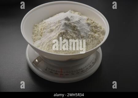 Homemade, tabletop, white weights with wheat flour are located on the gray countertop of the kitchen. Stock Photo