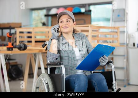 disable female carpenter using a saw Stock Photo