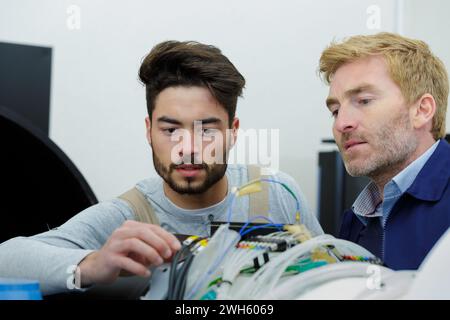 two technicians working on a machine Stock Photo