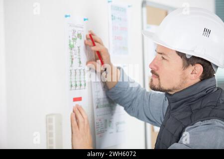 builder writing on board in office Stock Photo