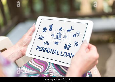 Personal loan concept shown on a tablet held by a woman Stock Photo