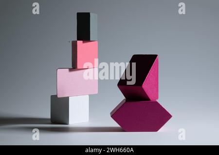 Pink and grey toy blocks on grey background Stock Photo