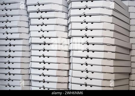 Several rows of pizza boxes, white pizza packing containers Stock Photo