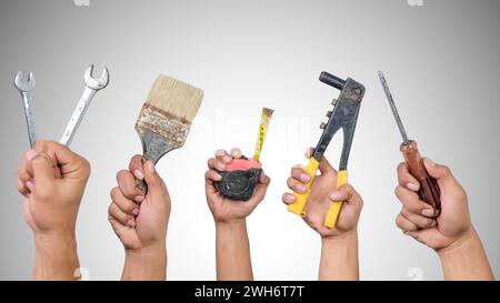 Hands holding different carpentry tools Stock Photo