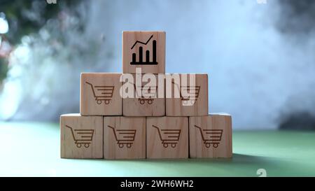 Business sales growth and expansion store franchise concept, Wooden cube block with chart icon and shopping trolley Stock Photo