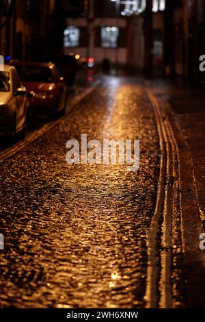 empty wet cobblestoned street lane at night belfast northern ireland uk Stock Photo