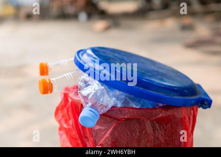 Several plastic water bottles in a recycling bin on a blurred background Stock Photo