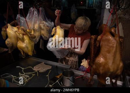 Bangkok, Thailand. 08th Feb, 2024. A vendor prepares boiled chicken for customer at Chinatown ahead of the Chinese Lunar New Year in Bangkok. The Chinese Lunar New Year will marked on 10 January 2024 and also marks the beginning of the Year of the Dragon. Credit: SOPA Images Limited/Alamy Live News Stock Photo