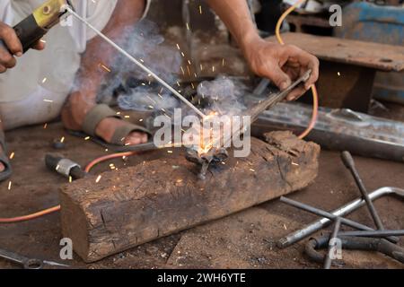 Welders work on welding metal. Men working in welding workshop Stock Photo
