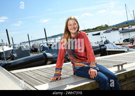 Katie McCabe aged 14 is the youngest person to sail single-handedly around the coast of Britain 2021 . Pictured at Topsham Quay in Devon Stock Photo