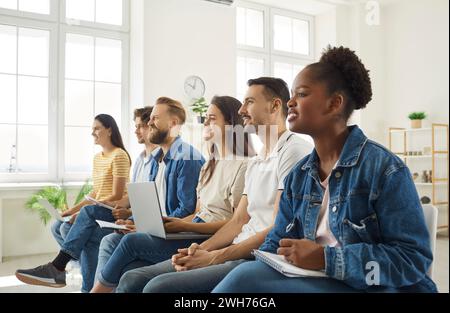 Male and female adult students listening attentively during workshop Stock Photo