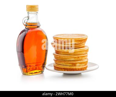 Pancakes and maple syrup in bottle isolated on the white backgorund. Stock Photo