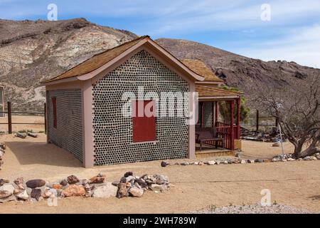 The Bottle House in the ghost town of Rhyolite, Nevada, was built by a miner in 1906 from 50,000 discarded beer & liquor bottles.  An early example of Stock Photo