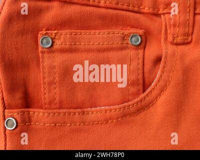Orange jeans pocket on the right side. Vertical background Stock Photo