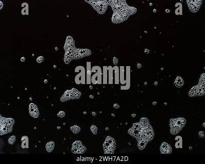 Bubbles soap foam splattered concept texture isolated on black background Stock Photo
