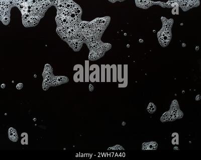 Bubbles soap foam splattered concept texture isolated on black background Stock Photo