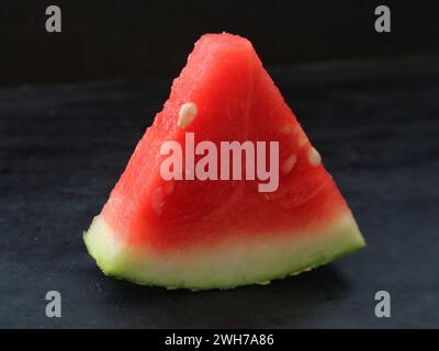 Sliced ​​watermelon fruit contains a lot of water and sweet taste.isolated on black background Stock Photo
