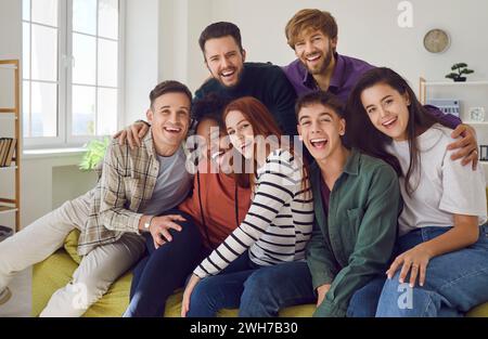 Group Portrait of a Young Diverse Friends Laughing on the Sofa Stock Photo