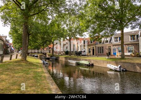 Achterom canal with small boats and houses in old town of Medemblik, Noord-Holland, Netherlands Stock Photo