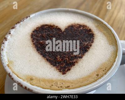 Viewed from top a cup of frothy coffee with a love heart made of chocolate sprinkles.Romatic.Valentine Day Stock Photo