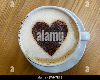 viewed from top a cup of coffee with a chocolate heart design created by the barrista.Romantic.Valentines Day Stock Photo