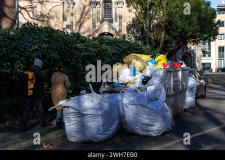 a container and heavy-duty sacks of construction waste are standing in front of St. Gereon Church, Cologne, Germany. ein Container und Schwerlastsaeck Stock Photo