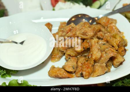 Stuffed cabbage with sour cream in white casserole Stock Photo