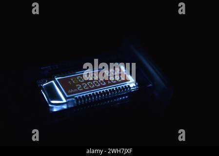 USB measuring device. The electrical meter of the USB devices. The screen of the device in the night. Stock Photo