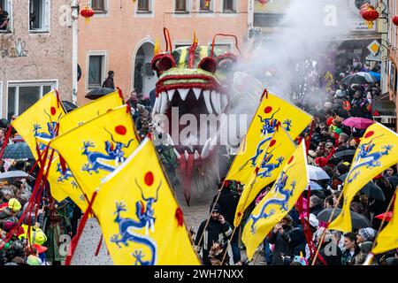 Dietfurt, Germany. 08th Feb, 2024. A Chinese dragon takes part in the traditional Chinese carnival parade. As every year on 'Nonsensical Thursday', jesters dressed as Asians parade through the town. The Chinese carnival goes back to a legend according to which the people of Dietfurt simply left a tax collector standing outside the town wall in the Middle Ages. The treasurer is said to have subsequently complained to the bishop, his employer, that the people of Dietfurt were hiding behind their wall 'like the Chinese'. Credit: Armin Weigel/dpa/Alamy Live News Stock Photo