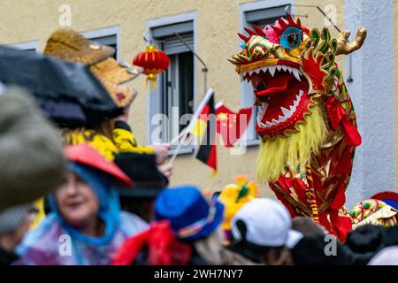 Dietfurt, Germany. 08th Feb, 2024. A Chinese dragon can be seen in the parade at the traditional Chinese carnival. As every year on 'Nonsensical Thursday', jesters dressed as Asians parade through the town. The Chinese carnival goes back to a legend according to which the people of Dietfurt simply left a tax collector standing outside the town wall in the Middle Ages. The treasurer is said to have subsequently complained to the bishop, his employer, that the people of Dietfurt were hiding behind their wall 'like the Chinese'. Credit: Armin Weigel/dpa/Alamy Live News Stock Photo