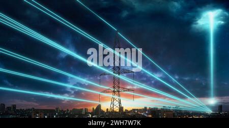 Power towers with blue wires glowing against the background of a night city and starry sky. A beam of energy strikes the sky. Stock Photo