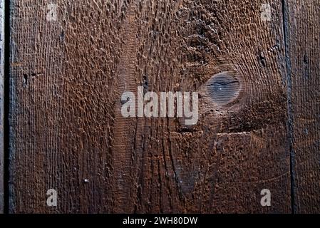 The texture of very old wood painted with brown paint. Stock Photo