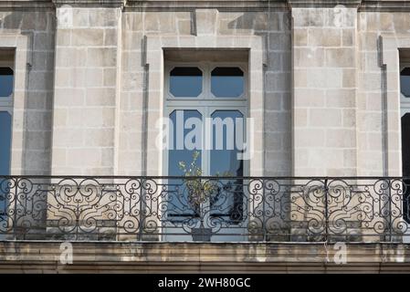 Facade with windows in an old tenement house in France, French architecture. Stock Photo