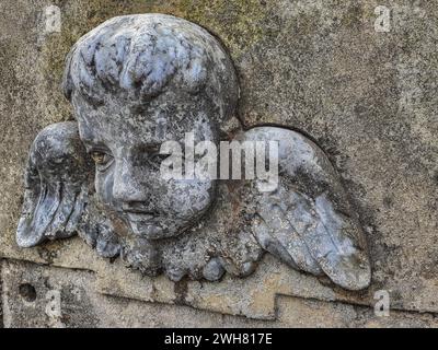 Historic angel bas -relief in an old forgotten cemetery Stock Photo