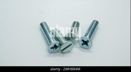 Four hexagonal bolts arranged on a white background Stock Photo