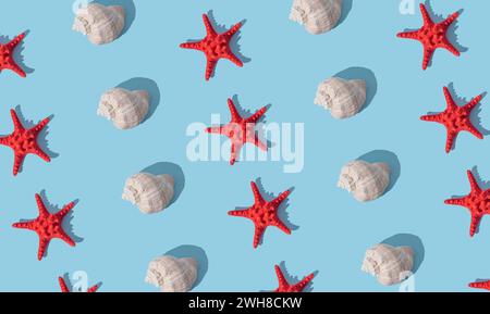 Trendy sunlight summer pattern made with sea shell and red starfish on light blue background. Minimal summer concept. Creative sea shell and starfish Stock Photo