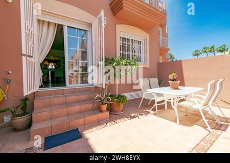 a luxury garden terrace with table and chairs in a mediterranean holiday home Stock Photo