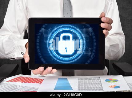 Businessman holding tablet computer and digital lock icon interface with circle binary numders and world map. Cyber security and digital protection co Stock Photo